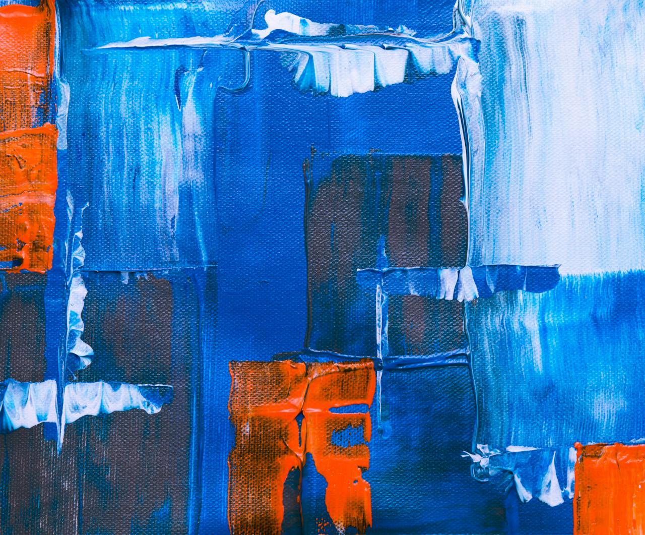Dynamic abstract painting with vibrant blue and orange acrylics on canvas, showcasing modern artistic expression.