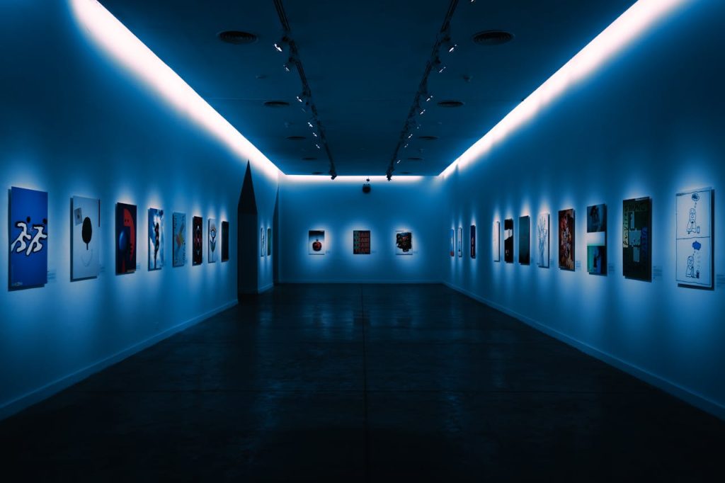 Contemporary artworks displayed in a dimly lit modern gallery space in Buenos Aires.